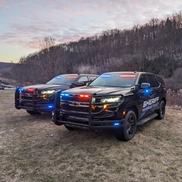 Two matching Tahoe PPVs with police lights on